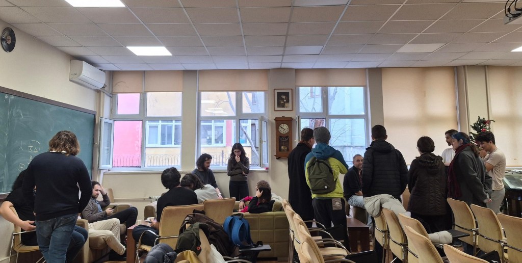 ISTringy participants gathering and talking in a seminar room in Istanbul